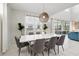 Bright dining area features a modern light fixture, large windows, and a contemporary white dining table at 1817 Caribbean View Ter, Kissimmee, FL 34747