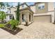 Charming home showcases a stylish facade with a covered porch, beautiful landscaping and a paved driveway at 1817 Caribbean View Ter, Kissimmee, FL 34747