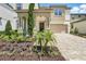 Charming home showcases a stylish facade with a covered porch, beautiful landscaping and a paved driveway at 1817 Caribbean View Ter, Kissimmee, FL 34747