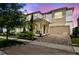 Elegant two-story home featuring a welcoming front porch and a brick driveway, perfect for curb appeal at 1817 Caribbean View Ter, Kissimmee, FL 34747