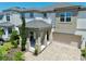Charming two-story home with a covered front porch, two-car garage, and a beautifully paved driveway at 1817 Caribbean View Ter, Kissimmee, FL 34747