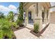 Inviting front porch features stylish columns, cozy seating, and a beautifully paved walkway, enhancing the home's charm at 1817 Caribbean View Ter, Kissimmee, FL 34747
