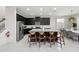 A kitchen island offers seating with an adjacent dining area and modern appliances at 1817 Caribbean View Ter, Kissimmee, FL 34747
