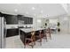 Modern kitchen with stainless steel appliances, seating at the island, and a modern lighting fixture at 1817 Caribbean View Ter, Kissimmee, FL 34747
