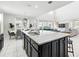 Spacious kitchen with granite countertops, barstool seating, and an open view to the living room at 1817 Caribbean View Ter, Kissimmee, FL 34747