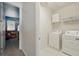 Laundry room with white appliances and doorway to a 'Cars' themed room at 1817 Caribbean View Ter, Kissimmee, FL 34747