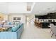 Open-concept floorplan showing a living room leading into a modern kitchen at 1817 Caribbean View Ter, Kissimmee, FL 34747