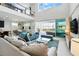 Bright, open living room with a soaring ceiling and access to the outdoor living space at 1817 Caribbean View Ter, Kissimmee, FL 34747