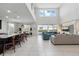 Spacious open-concept living area with high ceilings, ample natural light, and seamless flow to the kitchen and dining area at 1817 Caribbean View Ter, Kissimmee, FL 34747