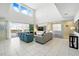 Bright and airy living room featuring a two-story ceiling, large windows, and comfortable seating with access to the backyard at 1817 Caribbean View Ter, Kissimmee, FL 34747