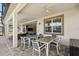 Spacious covered patio with tables and chairs, offering an ideal space for outdoor entertaining and dining at 1817 Caribbean View Ter, Kissimmee, FL 34747