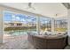 Screened-in patio area with a wicker couch, overlooking the pool and backyard at 1817 Caribbean View Ter, Kissimmee, FL 34747