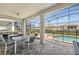 Covered patio area includes a dining table and chairs with view of pool and fenced backyard at 1817 Caribbean View Ter, Kissimmee, FL 34747