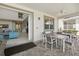 Covered patio with two tables and chairs, and access to the home's interior with large sliding doors at 1817 Caribbean View Ter, Kissimmee, FL 34747