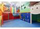 Fun playroom with colorful walls, climbing structure, and cartoon murals at 1817 Caribbean View Ter, Kissimmee, FL 34747