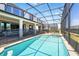 Swimming pool and spa surrounded by a screened enclosure, creating a private backyard oasis at 1817 Caribbean View Ter, Kissimmee, FL 34747