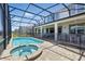Beautiful pool and hot tub surrounded by a screened enclosure in a backyard at 1817 Caribbean View Ter, Kissimmee, FL 34747