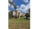 Two-story home featuring an arched entryway, lush green front lawn, and manicured landscaping at 1960 Aspenridge Ct, Ocoee, FL 34761