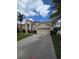 Two-story home featuring a two-car garage, arched entryway, and a well-maintained lawn at 1960 Aspenridge Ct, Ocoee, FL 34761