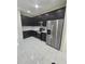 Modern kitchen featuring stainless steel appliances, dark cabinetry, and light countertops at 1960 Aspenridge Ct, Ocoee, FL 34761