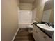 Bathroom with tub, shower and sleek vanity with white cabinet at 19935 Villa Isle Dr # 107, Orlando, FL 32821