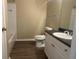 Bathroom featuring a tub with white tile surround, sleek vanity, and toilet at 19935 Villa Isle Dr # 107, Orlando, FL 32821