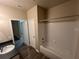 Well-lit bathroom with shower-tub combo and modern vanity, complemented by wood-look flooring at 19935 Villa Isle Dr # 107, Orlando, FL 32821