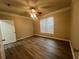 Bedroom featuring wood floors, ceiling fan and a large window offering plenty of natural light at 19935 Villa Isle Dr # 107, Orlando, FL 32821