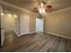Cozy bedroom featuring wood-look flooring, ceiling fan, and neutral paint at 19935 Villa Isle Dr # 107, Orlando, FL 32821