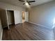Bedroom featuring wood-look flooring, a ceiling fan, and closet with open doors at 19935 Villa Isle Dr # 107, Orlando, FL 32821