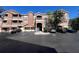 Exterior view of condominium building with car parking and balconies under a bright blue sky at 19935 Villa Isle Dr # 107, Orlando, FL 32821