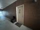 Hallway with a neutral color scheme, featuring an entrance door and a convenient storage box at 19935 Villa Isle Dr # 107, Orlando, FL 32821