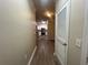 Hallway leading to the kitchen showcasing wood-look floors and natural light at 19935 Villa Isle Dr # 107, Orlando, FL 32821