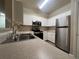 Kitchen features stainless steel appliances, ample countertop space and white cabinetry at 19935 Villa Isle Dr # 107, Orlando, FL 32821