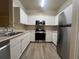 Well-equipped kitchen with stainless steel appliances and white cabinets, ensuring functionality and style at 19935 Villa Isle Dr # 107, Orlando, FL 32821