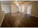 Inviting living room with wood-look flooring, ceiling fan, and natural light from large windows at 19935 Villa Isle Dr # 107, Orlando, FL 32821