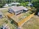 Aerial view showcasing the home's backyard with wood fencing, landscaping, and screened in patio at 2317 10Th St, St Cloud, FL 34769