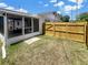 The screened-in lanai has access to the fenced in backyard with a stone walkway to the grassy area at 2317 10Th St, St Cloud, FL 34769