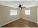 Bedroom with two windows, wood-look flooring, and a ceiling fan at 2317 10Th St, St Cloud, FL 34769