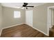 A bright bedroom features wood-look floors, a ceiling fan, and a large window for natural light at 2317 10Th St, St Cloud, FL 34769