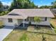 Charming single-story home featuring a freshly painted driveway and well-maintained landscaping at 2317 10Th St, St Cloud, FL 34769