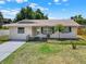 Charming single story home featuring a well-maintained lawn, fresh paint, and a decorative front door at 2317 10Th St, St Cloud, FL 34769