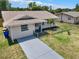 Charming single story home featuring a well-maintained lawn, fresh paint, and a decorative front door at 2317 10Th St, St Cloud, FL 34769