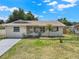 Charming single story home featuring a well-maintained lawn, fresh paint, and a decorative front door at 2317 10Th St, St Cloud, FL 34769