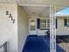 Inviting front porch featuring patterned tile, decorative white columns, and a view of the landscaped front yard at 2317 10Th St, St Cloud, FL 34769
