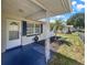 Inviting front porch featuring patterned tile, decorative white columns, and a view of the landscaped front yard at 2317 10Th St, St Cloud, FL 34769