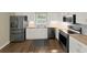 Renovated kitchen features stainless steel appliances, butcher block countertops and white cabinets at 2317 10Th St, St Cloud, FL 34769