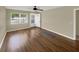 The light and bright living room showcases wood floors, a ceiling fan, neutral paint, and a window at 2317 10Th St, St Cloud, FL 34769