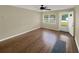 The light and bright living room showcases wood floors, a ceiling fan, neutral paint, and a window at 2317 10Th St, St Cloud, FL 34769