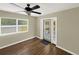 The light and bright living room showcases wood floors, a ceiling fan, neutral paint, and a glass door at 2317 10Th St, St Cloud, FL 34769